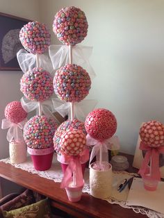 a table topped with lots of candy covered lollipops