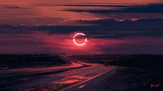 the eclipse is seen over an empty highway