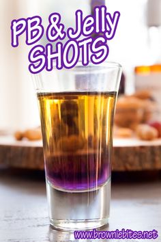 a glass filled with liquid sitting on top of a table