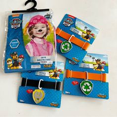 three children's wristbands with paw patrol characters on them and tags attached to them