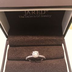 an engagement ring in a box with the name jared on it's side