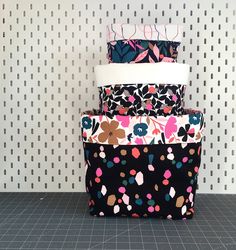 a stack of four bags sitting on top of a tiled floor next to a wall