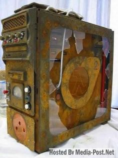 an old television made out of metal and wood with some wires attached to the side