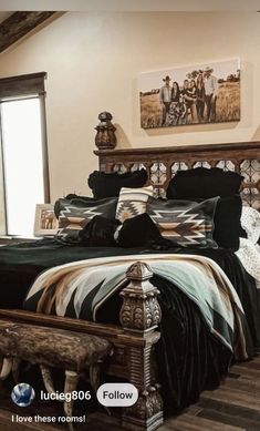 a large bed sitting inside of a bedroom on top of a hard wood floor next to a window