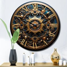 a gold and black clock sitting on top of a wooden table next to vases