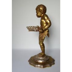 a statue of a boy holding a tray