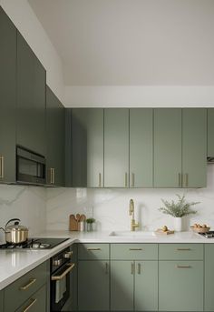 the kitchen is clean and ready for us to use it's green cabinetry