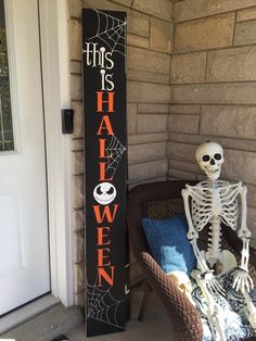 a skeleton sitting on a chair next to a halloween sign