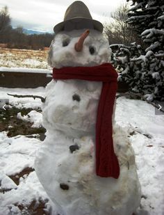 a snowman wearing a red scarf and hat