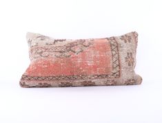 an orange and beige pillow on a white background