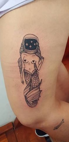 a woman with a tattoo on her stomach wearing a sailor hat and holding a fish