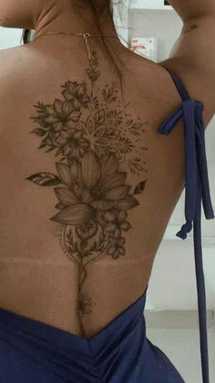 the back of a woman's body with flowers on it