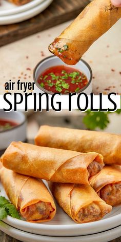 an air fryer spring rolls on a plate with dipping sauce