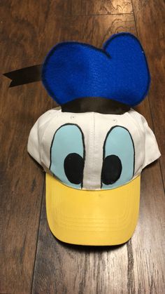 a mickey mouse hat on top of a wooden floor