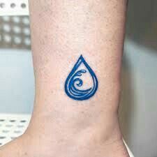 a blue water drop tattoo on the ankle