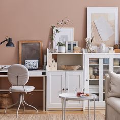 a living room filled with furniture next to a white table and chair on top of a hard wood floor