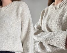 two women wearing sweaters with their arms crossed and one woman's hand on her hip