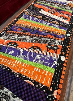 a table runner made with halloween themed fabric