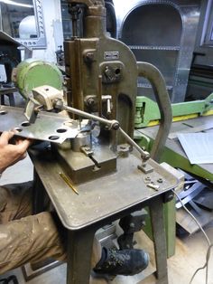 a man working on a machine in a shop