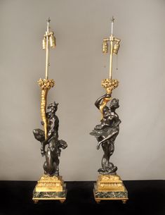 pair of bronze and marble candlesticks with cherubs on base, 19th century