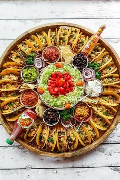 a platter filled with lots of different types of food and condiments on it