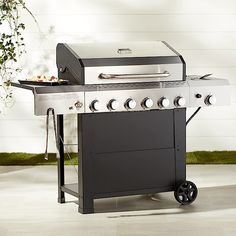 an outdoor grill is shown with the lid on it's side and two burners