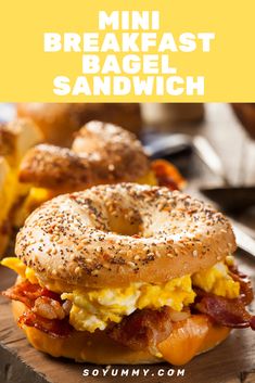 a bagel sandwich with bacon and eggs on it