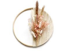 a piece of fabric with flowers on it sitting on top of a wooden circular frame