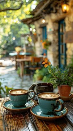 two cups and saucers sitting on a wooden table