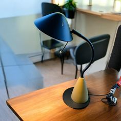 a desk lamp sitting on top of a wooden table