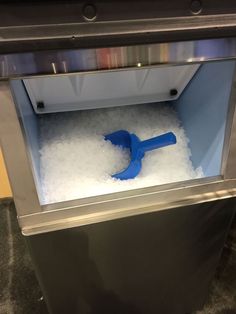 there is a blue tool in the middle of some white foam inside an ice chest