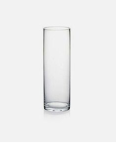 a tall glass vase sitting on top of a table