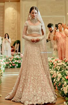 a woman in a wedding dress standing next to flowers