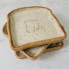 three ceramic dishes stacked on top of each other with the word i am written on them