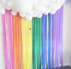 a room filled with balloons and streamers hanging from the ceiling