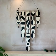 a wall hanging made out of black and white circles