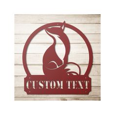 a metal sign that says custom text with a fox in the center on a wooden background