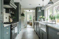 a kitchen with blue cabinets and white counter tops, along with an open floor plan