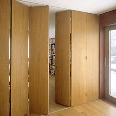 an empty room with wooden walls and sliding doors