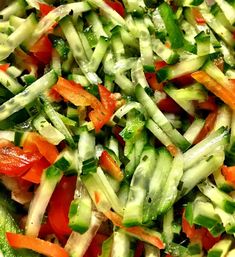 a salad with cucumbers, carrots and other veggies in it