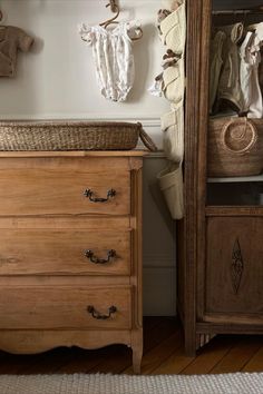 a baby crib in the corner of a room next to a dresser and mirror