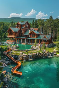 an aerial view of a large log home with a water slide in the foreground