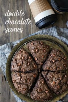 double chocolate scones on a plate next to a coffee cup and napkin with the words double chocolate scones