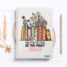 there is no such thing as too many books with flowers in them on top of a table