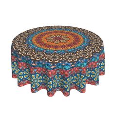 a round tablecloth with an intricate design on it's center and colorful flowers in the middle