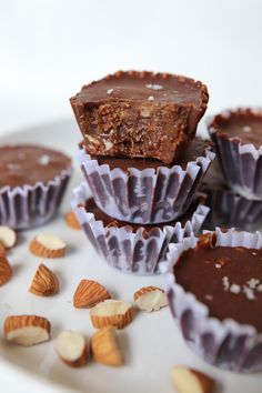 chocolate cups filled with nuts and almonds on a plate