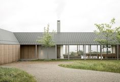 the house is surrounded by grass and trees