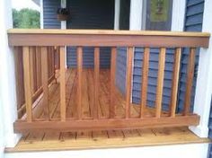 a wooden deck with railings on a house