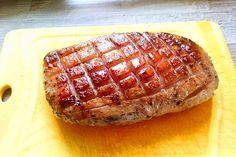 a piece of meat sitting on top of a yellow tray