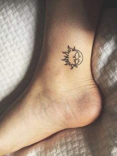 a small tattoo on the foot of a person with sun and moon in it's center